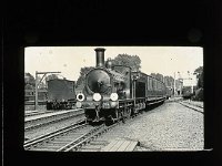 &copyTheCarterTribe.com 2013  No. 355 of the '700' class of thirty goods engines built in 1897 by Dubs and Company of Glasgow for the London and South Western Railway to the design of Dugald Drummond. Several of the class were re-numbered in 1898, taking numbers from withdrawn locomotives, thus No.715 became No.355 at that time. The head-code denotes a 'Through Goods or Mineral' train and in this case an 'Empty Stock' train, which is seen leaving from the west end of Bournemouth Central station c.1910. (Information from  Gareth Spencer and  Transports of Delight  26/06/2019).   Scanned from a 3.25" glass slide.